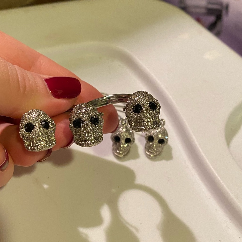 Three skull two finger Ring. also matching earrings it can be sold as a set.